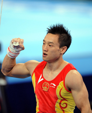 China&apos;s Yang Wei reacts after his performance of the rings during gymnastics artistic men&apos;s team final of the Beijing 2008 Olympic Games at National Indoor Stadium in Beijing, China, Aug. 12, 2008. (Xinhua/Cheng Min)