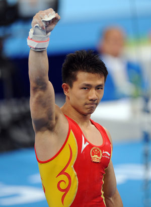 China&apos;s Chen Yibing holds up his fist after his performance of the horizontal bar during gymnastics artistic men&apos;s team final of the Beijing 2008 Olympic Games at National Indoor Stadium in Beijing, China, Aug. 12, 2008. (Xinhua/Cheng Min)