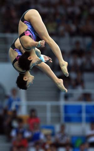 China’s Chen Ruolin (front)/Wang Xin compete during the women&apos;s synchronized 10m platform at the Beijing 2008 Olympic Games in the National Aquatics Center, also known as the Water Cube in Beijing, China, Aug. 12, 2008. Chen Ruolin/Wang Xin won the gold medal in the event with a score of 363.54 points. (Xinhua/Liu Yu) 