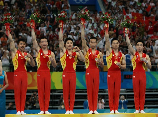 China's formidable male gymnasts stormed to a long-awaited Olympic team gold medal before an ecstatic home crowd on Tuesday. They claimed the title at 286.125 points, beating defending Olympic champion Japan to second place by a comfortable margin of 7.25 points. The United States took the bronze in 275.850 points. [Xinhua]