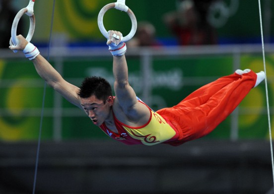 China's formidable male gymnasts stormed to a long-awaited Olympic team gold medal before an ecstatic home crowd on Tuesday. They claimed the title at 286.125 points, beating defending Olympic champion Japan to second place by a comfortable margin of 7.25 points. The United States took the bronze in 275.850 points. [Xinhua]