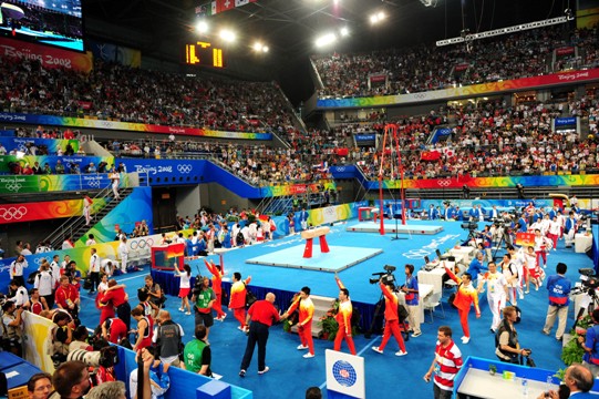 China's formidable male gymnasts stormed to a long-awaited Olympic team gold medal before an ecstatic home crowd on Tuesday. They claimed the title at 286.125 points, beating defending Olympic champion Japan to second place by a comfortable margin of 7.25 points. The United States took the bronze in 275.850 points. [Xinhua]