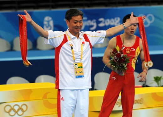 China's formidable male gymnasts stormed to a long-awaited Olympic team gold medal before an ecstatic home crowd on Tuesday. They claimed the title at 286.125 points, beating defending Olympic champion Japan to second place by a comfortable margin of 7.25 points. The United States took the bronze in 275.850 points. [Xinhua]