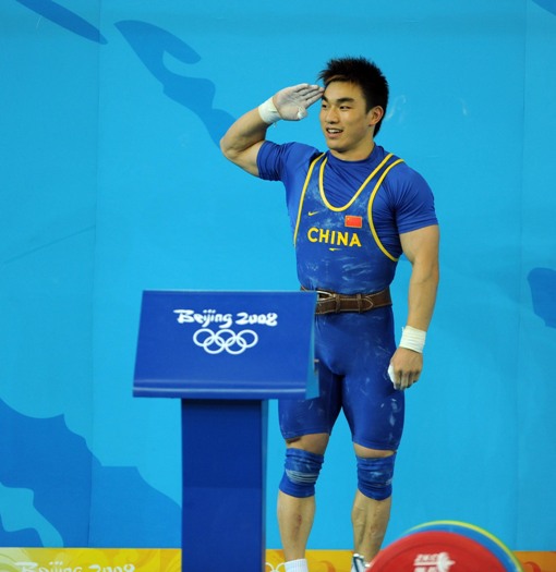 Liao Hui of China celebrates after taking a successful lift during the men's 69kg final of weightlifting at Beijing 2008 Olympic Games in Beijing, China, Aug. 12, 2008. Liao won the gold medal with a total of 348 kilos. [Xinhua]