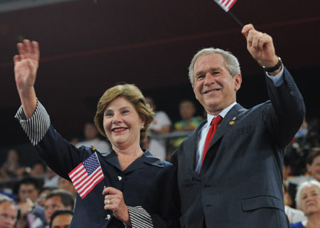U.S. President George W. Bush (R) and his wife Laura Bush wave to the Olympic delegation of the United States at the opening ceremony of the Beijing Olympics in the National Stadium in north Beijing, China, Aug. 8, 2008. (Xinhua/Huang Jingwen)
