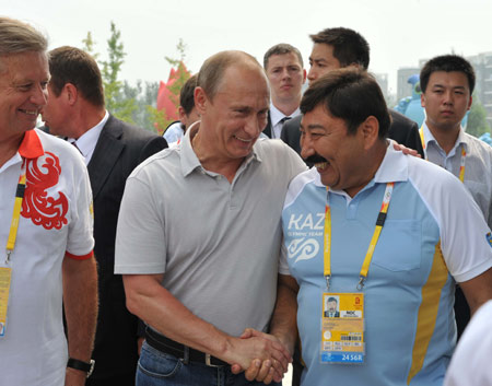 Russian Prime Minister Vladimir Vladimirovic Putin (2nd L front) shakes hands with Kazak Olympic committee official Temirkhan Dosmukhambetou at the Olympic Village in Beijing, China, Aug. 9, 2008. Vladimir Vladimirovic Putin visited the Olympic Village and met the Russian athletes here on Saturday. (Xinhua/Zhang Guojun)