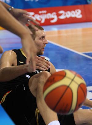Dirk Nowitzki (R) of Germany falls on the pitch during Men's Preliminary Round Group B-Game 21 between Germany and Greece of Beijing 2008 Olympic Games basketball event at the Beijing Olympic Basketball Gymnasium in Beijing, China, Aug. 12, 2008. Greece beat Germany 87-64. 