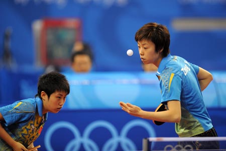 Zhang Yining (R) and Guo Yue of China compete against Andrea Bakula and Sandra Paovic of Croatia during the women's team group match at the Beijing 2008 Olympic Games table tennis event in Beijing, China, Aug. 13, 2008. China defeated Croatia 3-0. 