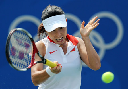 Zheng Jie of China hits a return against Nuria Llagostera Vives of Spain at the second round of women's singles during the Beijing Olympic tennis event in Beijing, China, Aug. 12, 2008. Zheng Jie beat Nuria Llagostera Vives 2-1. [Xinhua]