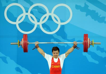 Zhang Xiangxiang of China takes a lift during men's weightlifting 62kg Group A competition of Beijing 2008 Olympic Games at Beijing University of Aeronautics & Astronautics Gymnasium in Beijing, China, Aug. 11, 2008. Zhang won the gold medal in the event. (Xinhua/Yang Lei) 