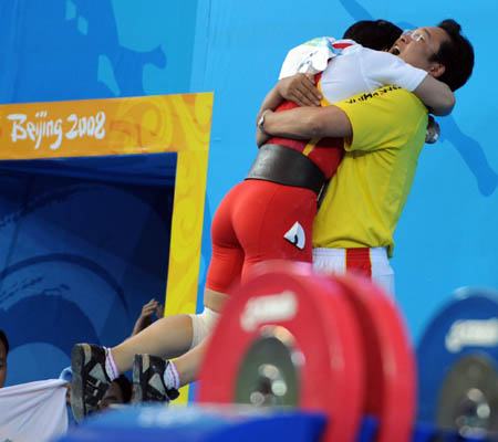 Liu Chunhong of China hugs her coach Ma Wenhui after winning the women's 69kg final of weightlifting at Beijing 2008 Olympic Games in Beijing, China, Aug. 13, 2008. Liu claimed the title in this event and set new world record of snatch lift with 128 kilos, new world record of clean and jerk lift with 158 kilos and also the new world record of total with 286 kilos. (Xinhua/Yang Lei) 