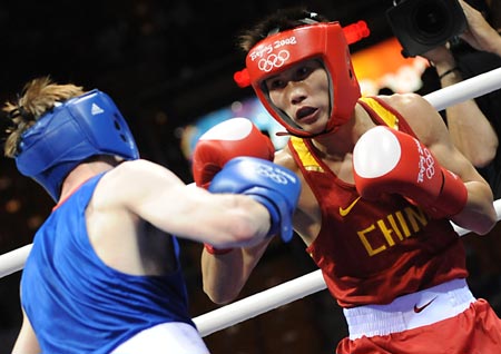 Gu Yu (red) of China fights with Joe Murrray of Great Britain during Men's Bantam (54kg) round of 32 at the Beijing Olympic Games boxing event in Beijing, China, Aug 12, 2008. Gu Yu of China won the match.[Xinhua]