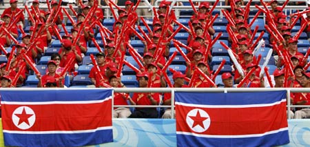 North Korean supporters cheer their team during a women's first round Group F soccer match against Germany at the Beijing 2008 Olympic Games in Tianjin August 12, 2008.[ Reuters]