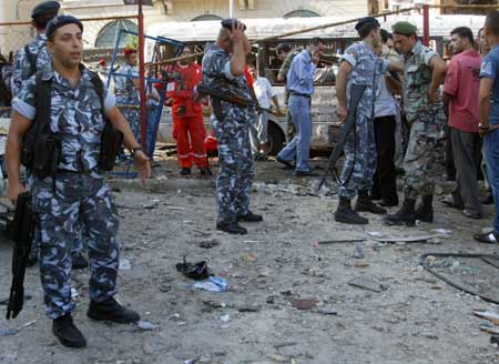 Soldiers inspect the area following a bomb blast in the port city of Tripoli in north Lebanon Aug. 13, 2008.(Xinhua/Reuters Photo)