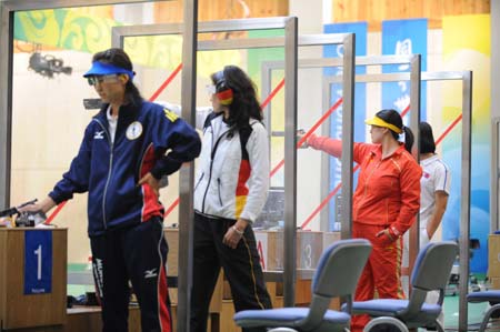 Chen Ying (red) of China competes during the women's 25m pistol final of the Beijing 2008 Olympic Games shooting event at the Beijing Shooting Range Hall in Beijing, China, Aug. 13, 2008. Chen Ying shot 793.4 points to win the gold medal of the event. [Xinhua]