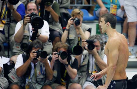 Michael Phelps of the United States reacts after winning the men's 200m butterfly final at the Beijing 2008 Olympic Games in the National Aquatics Center, also known as the Water Cube in Beijing, China, Aug. 13, 2008. Phelps set a new world record and won the gold medal in the event with 1 minute 52.03 seconds. (Xinhua/Fan Jun) 