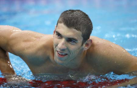 Michael Phelps of the United States smiles after winning the men's 200m butterfly final at the Beijing 2008 Olympic Games in the National Aquatics Center, also known as the Water Cube in Beijing, China, Aug. 13, 2008. Phelps set a new world record and won the gold medal in the event with 1 minute 52.03 seconds. (Xinhua/Ding Xu)