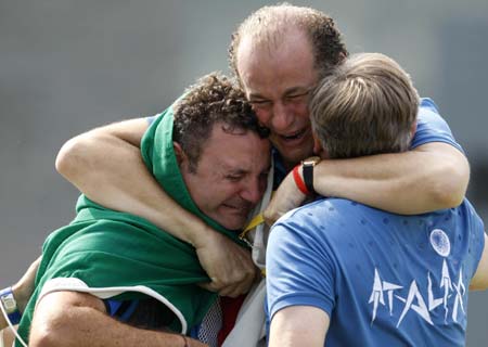 Francesco D Aniello (3rd R) of Italy embraces his coach after men's double trap final of the Beijing 2008 Olympic Games shooting event in Beijing, China, Aug. 12, 2008. The United States's Walton Eller won the gold medal with a total score of 190, followed by Italy's Francesco D Aniello of 187 and China's Hu Binyuan of 184. (Xinhua/Bao Feifei)