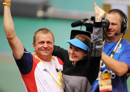 Markswoman Katerina Emmons (C) of Czech celebrates with her coach after women's 10m Air rifle final of Beijing Olympic Games at Beijing Shooting Range Hall in Beijing, China, Aug. 9, 2008. Katerina Emmons won the gold medal in the event with 503.5 points. (Xinhua/Li Ga)