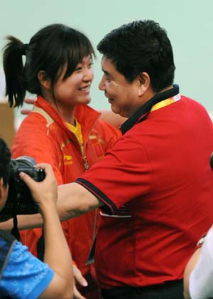 Guo Wenjun of China hugs the head coach Wang Yifu at the women's 10m air pistol final of shooting at Beijing 2008 Olympic Games in Beijing, China, Aug. 10, 2008. Guo won the gold medal in this event. (Xinhua/Li Ga)