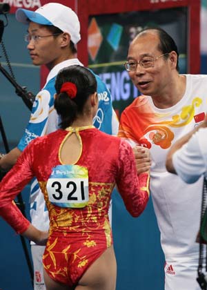 Cheng Fei of China talks with her coach after the floor exercises competition of gymnastics artistic women's qualification of Beijing 2008 Olympic Games at National Indoor Stadium in Beijing, China, Aug. 10, 2008. China's women gymnasts dominated the first qualification round with a total of 248.275 points at the Beijing Olympics on Sunday.(Xinhua/Ren Long)