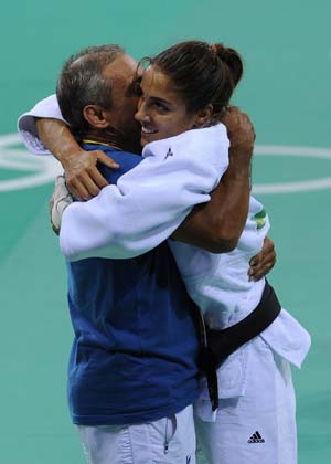 Giulia Quintavalle (R) of Italy celebrates with her coach after defeating Deborah Gravenstijn of Netherlands during the women's 57kg final of judo at the Beijing 2008 Olympic Games in Beijing, China, Aug. 11, 2008. Giulia Quintavalle claimed the title in this event. (Xinhua/Guo Dayue)