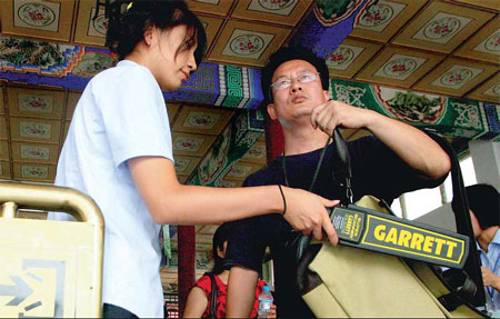 A visitor to Zhongshan Park undergoes a routine security check yesterday. [Wang Jing/China Daily]