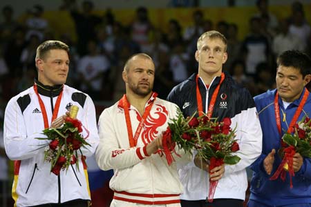 Gold medalists Aslanbek Khushtov (2nd L) of Russia, silver medalist Mirko Englich (1st L) of Germany, and bronze medalists Asset Mambetov (1st R) of Kazakhstan and Adam Wheeler of the United States stand on the podium during the awarding ceremony of the men’s Greco-Roman 96kg class at the Beijing 2008 Olympic Games wrestling event in Beijing, China, Aug. 14, 2008.