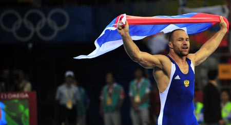 Aslanbek Khushtov of Russia celebrates after beating Mirko Englich of Germany during the men’s Greco-Roman 96kg final at the Beijing 2008 Olympic Games wrestling event in Beijing, China, Aug. 14, 2008. Aslanbek Khushtov won the bout and grabbed the gold medal. 