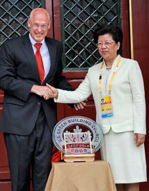 Chen Zhili (R), vice chairwoman of the Standing Committee of China's National People's Congress (NPC), vice president of the Beijing Organizing Committee of the 29th Olympic Games and mayor of the Beijing Olympic Village, shakes hands with US Treasury Secretary Henry Paulson during the awarding ceremony for the Beijing Olympic Village being granted the Leadership in Energy and Environmental Design (LEED) gold medal in Beijing on August. 13, 2008. (Xinhua Photo)
