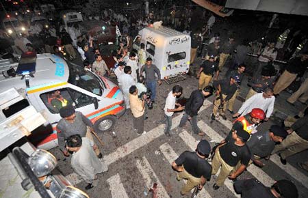 Pakistani security personnel gather at the site of a suicide attack in Lahore, Aug. 13, 2008. A suicide bomber blew himself up outside a police station in Lahore on Wednesday during preparations for Pakistan's Independence Day, killing at least seven people, police said.(Xinhua/AFP Photo)