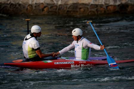 Gold medalist Michal Martikan (R) receives congratulations after winning the men's canoe single (C1) final of Olympic canoe/kayak slalom competition, in the Shunyi Rowing-Canoeing Park in Beijing, China, Aug. 12, 2008. (Xinhua/Liu Dawei) 