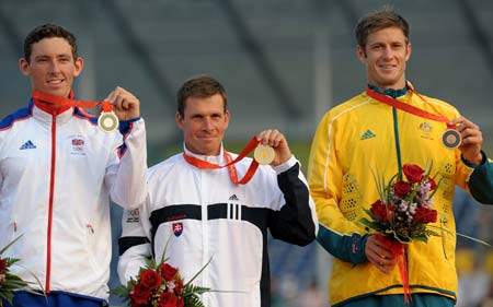 Gold medalist Michal Martikan (C), Silver medalist David Florence(L) of Great Britain, and Bronze medalist Robin Bell of Australia stand on the podium at the awarding ceremony of the men's canoe single(C1) final of Olympic canoe/kayak slalom competition, in the Shunyi Rowing-Canoeing Park in Beijing, China, Aug. 12, 2008. (Xinhua/Liu Dawei) 