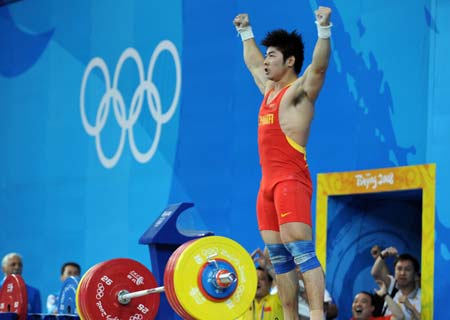 Lu Yong of China celebrates during the men's 85kg group A competition of the Beijing 2008 Olympic Games weightlifting event in Beijing, China, Aug. 15, 2008. Lu Yong won the gold with a total of 394 kg.(Xinhua/Yang Lei)