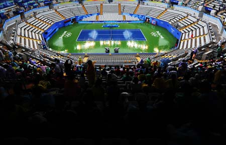 Audience wait for delayed Olympic tennis match on the stand at the Beijing Olympic Green Tennis Court in Beijing, China, Aug. 14, 2008. The Beijing 2008 Olympic Games tennis event was delayed Thursday due to rain.