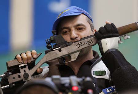 Artur Ayvazian of Ukraine kisses his rifle after winning the men's 50m rifle prone final of Shooting at Beijing 2008 Olympic Games in Beijing, China, Aug. 15, 2008. Artur Ayvazian claimed the gold with a total of 702.7. [Bao Feifei/Xinhua]