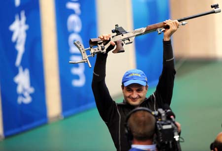 Artur Ayvazian of Ukraine celebrates after winning the men's 50m rifle prone final of Shooting at Beijing 2008 Olympic Games in Beijing, China, Aug. 15, 2008. Artur Ayvazian claimed the gold with a total of 702.7. [Bao Feifei/Xinhua]