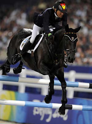 German rider Ingrid Klimke and horse Abraxxas jump during the eventing jumping competition of the Beijing 2008 Olympic Games equestrian events at Hong Kong Olympic Equestrian Venue (Sha Tin) in the Olympic co-host city of Hong Kong, south China, Aug. 12, 2008. Germany won the first Olympic Eventing Team gold medal in the three-day eventing here Tuesday night with a total penalty of 166.10. 