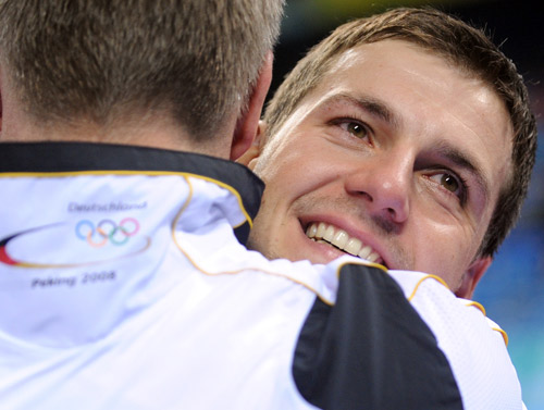 Timo Boll of Germany hugs his coach.[Xinhua]