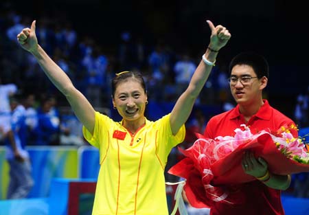 Zhang Ning (L) of China celebrates after defeating teammate Xie Xingfang at the women's singles gold medal match during the Beijing 2008 Olympic Games badminton event in Beijing on August 16, 2008. Zhang Ning won the match 2-1 and grabbed the gold medal of the event. (Xinhua/Luo Xiaoguang) 