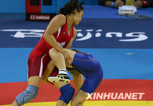 Canada's Carol Huynh beat Japan's Chiharu Icho to win the women's 48kg freestyle wrestling gold at the Beijing Olympic Games in Beijing on Saturday. 
