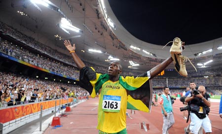 Usain Bolt of Jamaica celebrates after taking men's 100m final at the National Stadium, also known as the Bird's Nest, during Beijing 2008 Olympic Games in Beijing, China, Aug. 16, 2008. Usain Bolt claimed the title of the event and rewrote the world record to 9.69 secs.[Xinhua] 