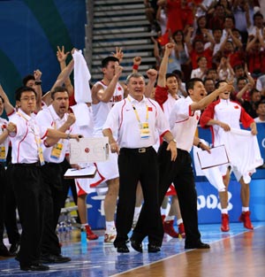Chinese players and coaches jubilate during the match China VS Germany in men's preliminary round group B of the Beijing 2008 Olympic Games Basketball event in Beijing, China, Aug. 16, 2008. 