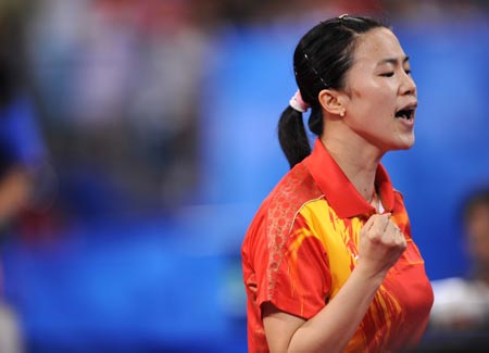 Wang Nan of China celebrates after defeating Feng Tianwei of Singapore during the women's team gold medal contest of Beijing Olympic Games table tennis event between China and Singapore in Beijing, China, Aug. 17, 2008. China beat Singapore 3-0 and claimed the title in this event. 