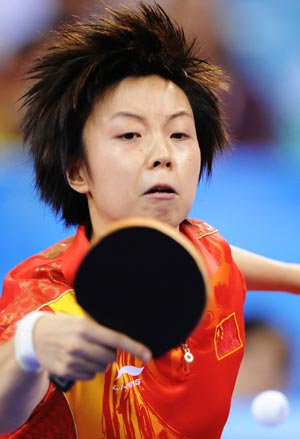 Zhang Yining of China returns the ball during the women's team gold medal contest of Beijing Olympic Games table tennis event between China and Singapore in Beijing, China, Aug. 17, 2008. China beat Singapore 3-0 and claimed the title in this event.