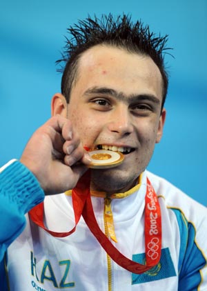 Gold medalist Ilya Ilin of Kazakhstan poses during the victory ceremony of men's weightlifting 94kg group A competition at Beijing 2008 Olympic Games in Beijing, China, Aug. 17, 2008. Ilya Ilin won the gold medal in the event with a total result of 406kg. 