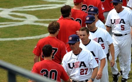 Baseballers (white) of the United States shake hands with their competitors of Canada after the match the United States VS Canada in Men's Preliminaries of the Beijing 2008 Olympic Games Baseball event in Beijing, China, Aug. 16, 2008. The United States beat Canada 5-4. [Zhang Ling/Xinhua]