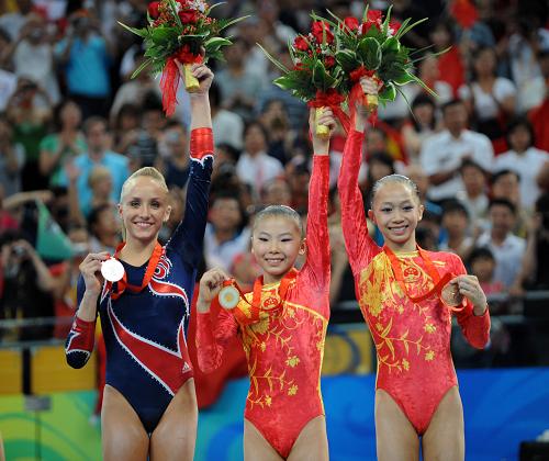 Chinese gymnast He kexin claimed the women's uneven bars title with 16.725 points at the Beijing Olympics on Monday. [Xinhua]