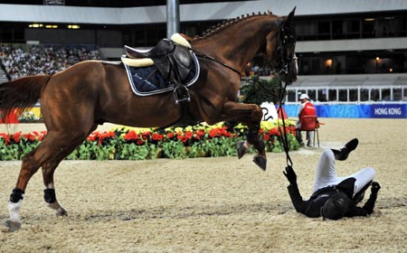 Azerbaijani rider Jamal Rahimov falls from his horse Ionesco de Brekka during the jumping individual 2nd qualifier competition of the Beijing 2008 Olympic Games equestrian events in the Olympic co-host city of Hong Kong, south China, Aug 17, 2008. Rahimov was eliminated from the competition due to his falling. 