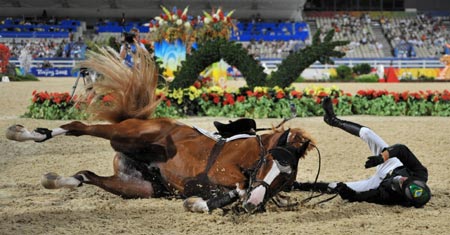 Brazilian rider Pedro Veniss falls from his horse Un Blanc De Blancs during the jumping individual 2nd qualifier and jumping team round 1 of the Beijing 2008 Olympic Games equestrian events in the Olympic co-host city of Hong Kong, south China, Aug 17, 2008. Pedro was eliminated from the competition after he fell off his horse. 